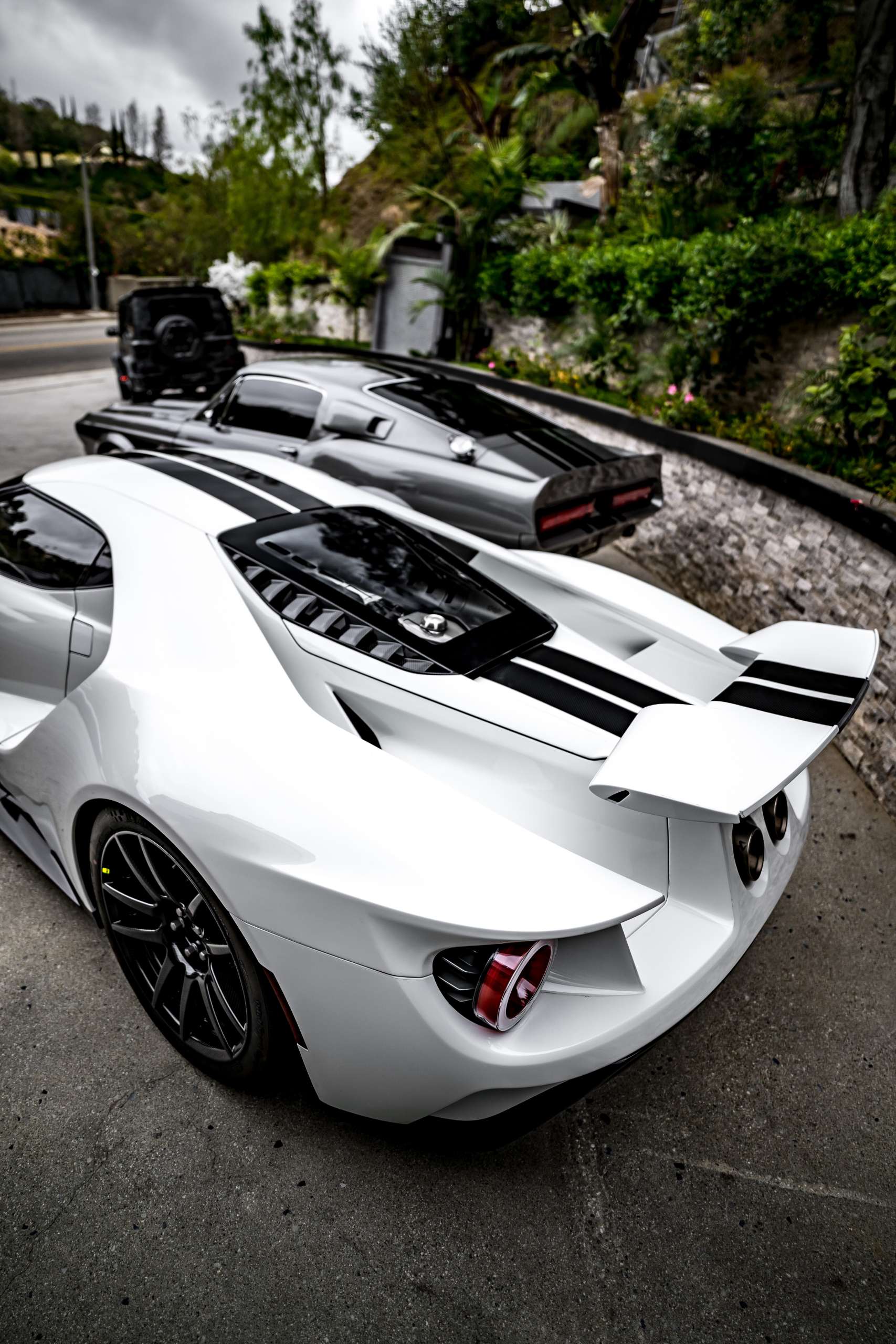 Jas Mathur photographed beside a luxury vehicle