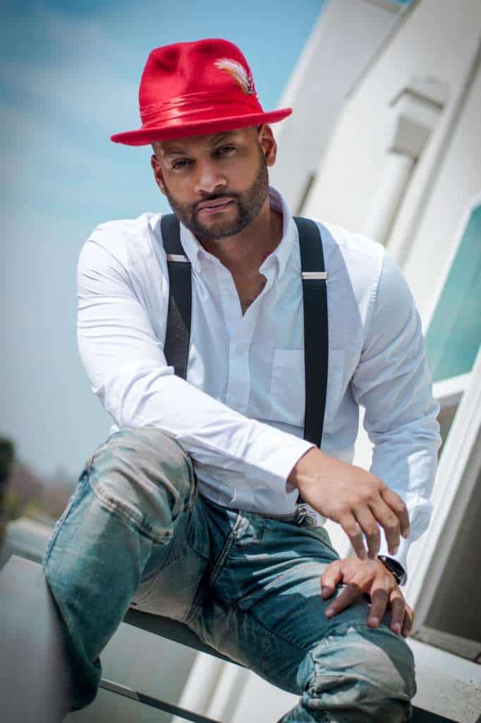 Red fedora hat and white shirt fashion portrait with casual urban style.