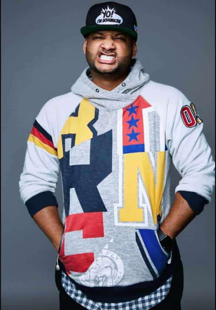 Vibrant streetwear hoodie with bold graffiti-inspired design, featuring colorful letters and patches, styled for urban fashion enthusiasts.