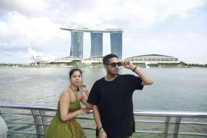 Paul and a companion on the waterfront with Marina Bay Sands across the bay