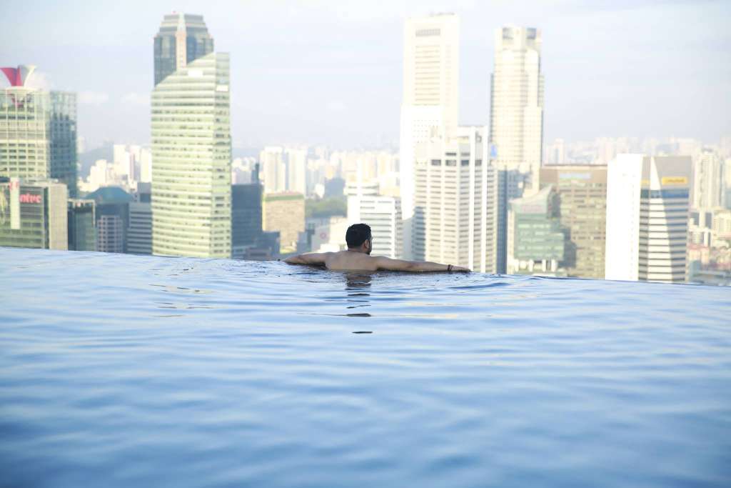 A guest looking across Singapore's skyline from the Marina Bay Sands infinity pool