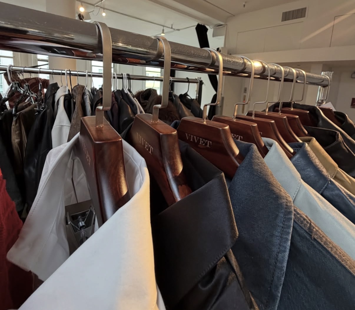 Vivet Collection 1 garments on branded hangers backstage