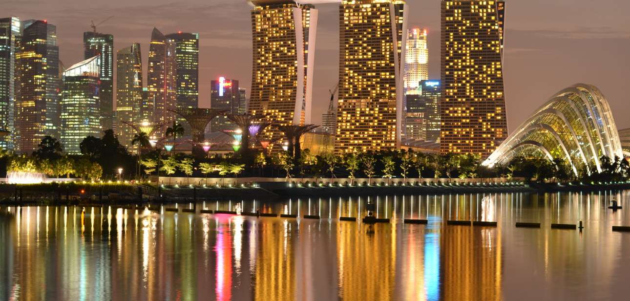 Marina Bay Sands and Singapore's central skyline reflected across the bay at dusk