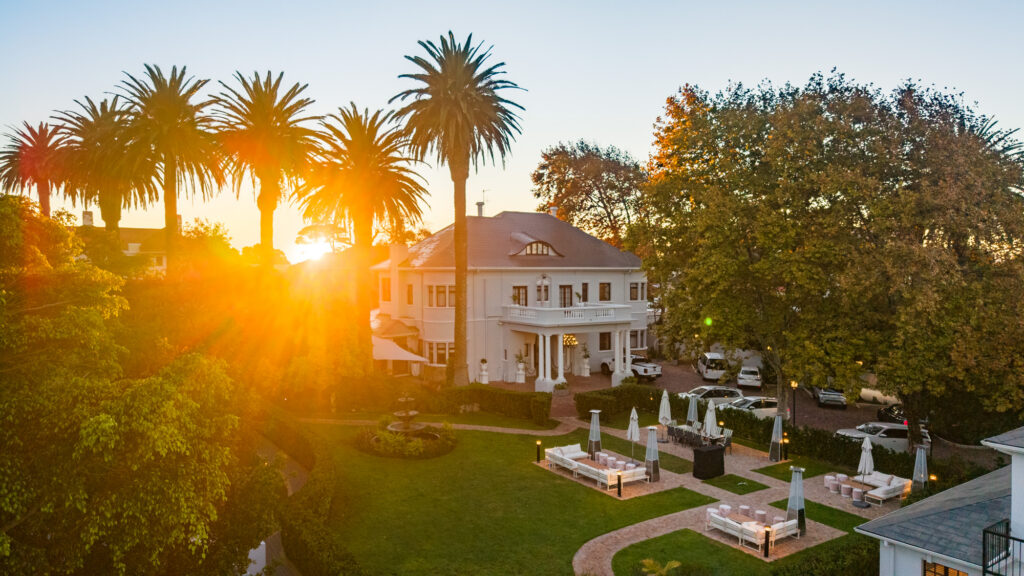 Palm House Boutique Hotel and Spa in Cape Town surrounded by landscaped gardens.