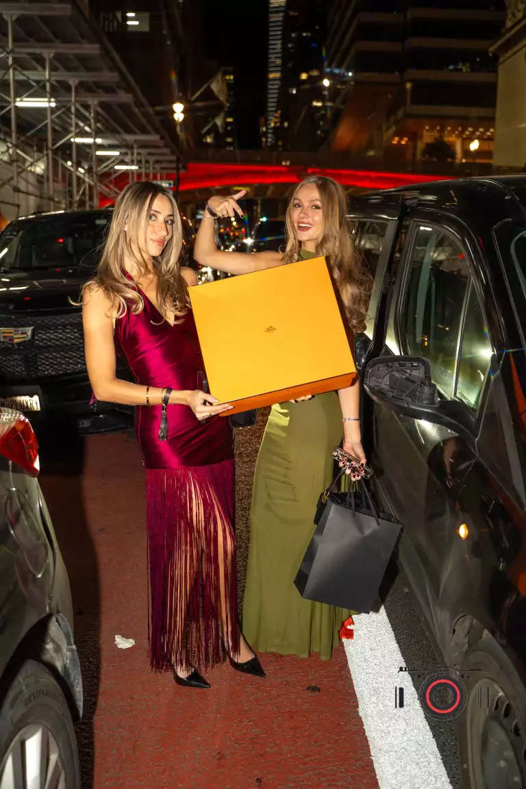 Guests hold a gift outside Casa Cipriani during Drake’s birthday celebration.