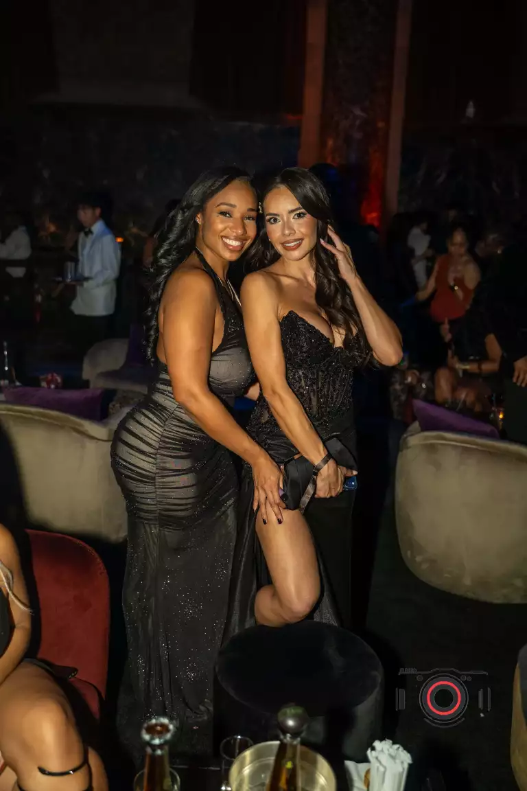 Two guests pose together inside Casa Cipriani during Drake’s birthday celebration.