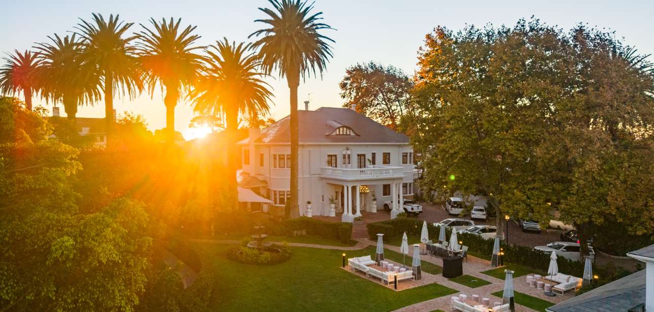 Palm House Boutique Hotel exterior among gardens in Cape Town