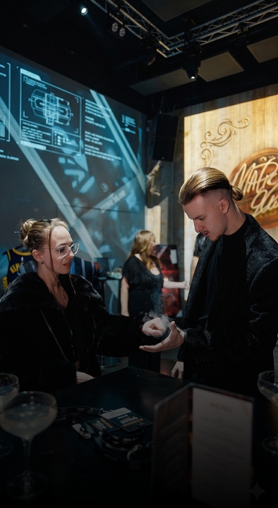 Roman Royss performing close-up magic at a corporate event