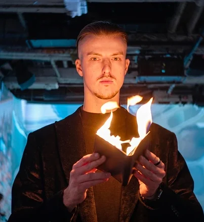 Roman Royss performing with a small flame in his hand