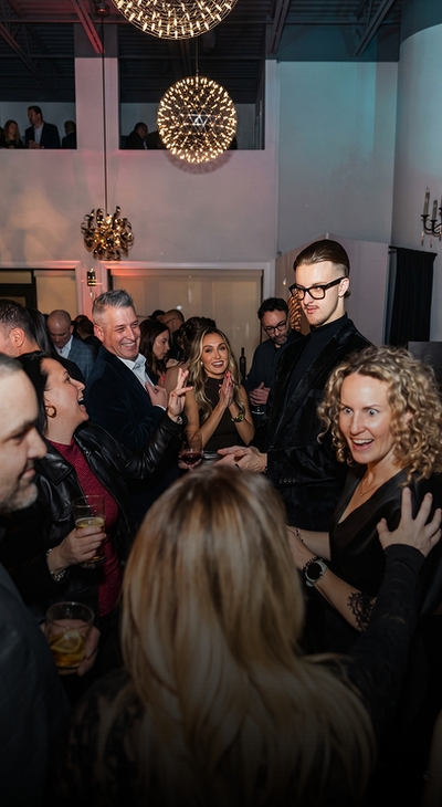 Guests watching Roman Royss perform at a private event